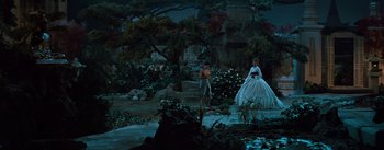 Movie still from “The King and I” (1956), directed by Walter Lang – A man and a woman dressed as pirates in a garden setting; Wide shot, High angle