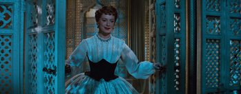 Movie still from “The King and I” (1956), directed by Walter Lang – A woman in a white and black dress standing in front of an open door; Medium shot, Low angle