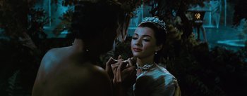 Movie still from “The King and I” (1956), directed by Walter Lang – A beautiful woman wearing a tiara while holding a ring; Close Up shot, Over the shoulder angle