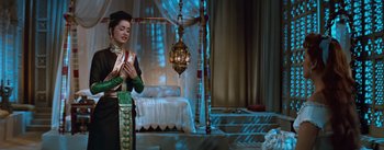 Movie still from “The King and I” (1956), directed by Walter Lang – A woman standing in front of a bed in a room; Medium shot, High angle
