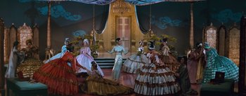 Movie still from “The King and I” (1956), directed by Walter Lang – A group of women dressed in fancy dresses; Wide shot, High angle