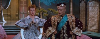Movie still from “The King and I” (1956), directed by Walter Lang – A man and a woman dressed up in costumes; Medium shot, Low angle