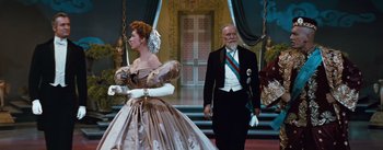 Movie still from “The King and I” (1956), directed by Walter Lang – An older man and a woman dressed in formal wear; Medium shot, Low angle