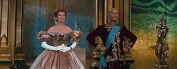 Movie still from “The King and I” (1956), directed by Walter Lang – A man and a woman dressed in formal wear; Medium shot, Low angle