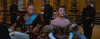 Movie still from “The King and I” (1956), directed by Walter Lang – A man and a woman sitting next to each other; Medium shot, Low angle
