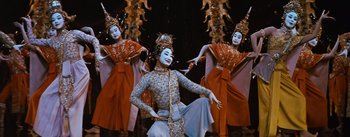 Movie still from “The King and I” (1956), directed by Walter Lang – A group of women in costumes performing a dance; Medium shot, Low angle