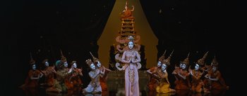 Movie still from “The King and I” (1956), directed by Walter Lang – A group of people dressed in costumes performing a dance; Wide shot, Low angle