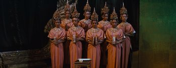 Movie still from “The King and I” (1956), directed by Walter Lang – A group of people in traditional dress holding candles; Wide shot, High angle
