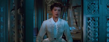 Movie still from “The King and I” (1956), directed by Walter Lang – A woman in a white dress standing in front of a mirror; Medium shot, Low angle