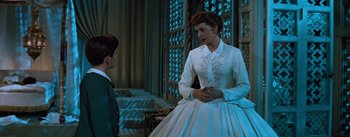Movie still from “The King and I” (1956), directed by Walter Lang – A woman in a white dress talking to a young boy; Medium shot, Low angle