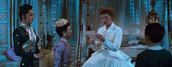 Movie still from “The King and I” (1956), directed by Walter Lang – A woman and a boy are looking at a piece of paper; Medium shot, Low angle
