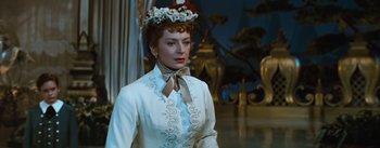 Movie still from “The King and I” (1956), directed by Walter Lang – A woman wearing a white dress and a flower crown; Close Up shot, Low angle