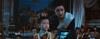 Movie still from “The King and I” (1956), directed by Walter Lang – A woman and a young girl in traditional dress; Close Up shot, Low angle
