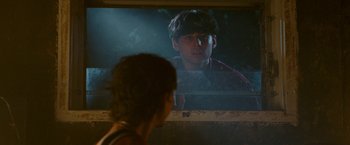 Movie still from “The King of Staten Island” (2020), directed by Judd Apatow – A person looking at a television screen with an image on it; Medium shot, Over the shoulder angle