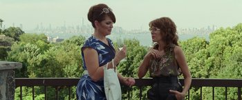 Movie still from “The King of Staten Island” (2020), directed by Judd Apatow – Two women standing next to each other holding wine glasses; Medium shot, Over the shoulder angle
