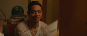 Movie still from “The King of Staten Island” (2020), directed by Judd Apatow – A person with a tattoo on his face; Close Up shot, Over the shoulder angle