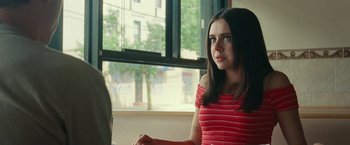 Movie still from “The King of Staten Island” (2020), directed by Judd Apatow – A woman sitting in front of a window looking at the camera; Close Up shot, Over the shoulder angle