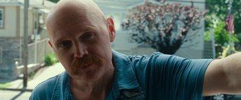 Movie still from “The King of Staten Island” (2020), directed by Judd Apatow – A man with a bald head and a mustache; Close Up shot, Over the shoulder angle