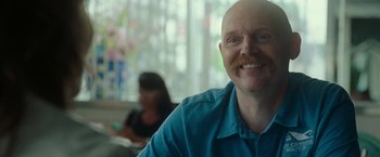 Movie still from “The King of Staten Island” (2020), directed by Judd Apatow – A man with a beard and a blue shirt is smiling for the camera; Close Up shot, Over the shoulder angle
