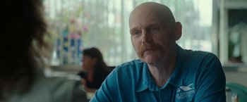 Movie still from “The King of Staten Island” (2020), directed by Judd Apatow – A man with a beard and mustache sitting at a table; Close Up shot, Over the shoulder angle