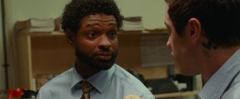 Movie still from “The King of Staten Island” (2020), directed by Judd Apatow – A man wearing a tie talking to another man; Close Up shot, Over the shoulder angle