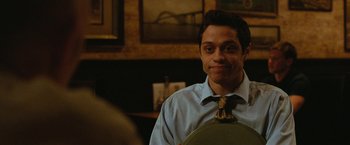 Movie still from “The King of Staten Island” (2020), directed by Judd Apatow – A man wearing a blue dress shirt and a tie; Close Up shot, Over the shoulder angle