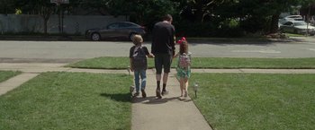 Movie still from “The King of Staten Island” (2020), directed by Judd Apatow – A man and two children walking down a sidewalk; Wide shot, Low angle