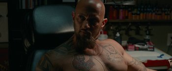 Movie still from “The King of Staten Island” (2020), directed by Judd Apatow – A man with a beard and tattoos on his chest; Close Up shot, High angle