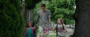 Movie still from “The King of Staten Island” (2020), directed by Judd Apatow – A man walking with two young children holding hands; Medium shot, Low angle