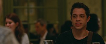 Movie still from “The King of Staten Island” (2020), directed by Judd Apatow – A man sitting at a table with a glass of wine; Close Up shot, Over the shoulder angle