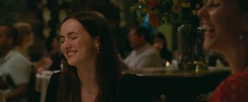Movie still from “The King of Staten Island” (2020), directed by Judd Apatow – A woman smiles while sitting at a table; Close Up shot, Over the shoulder angle