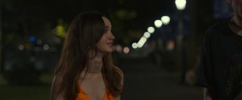 Movie still from “The King of Staten Island” (2020), directed by Judd Apatow – A woman in an orange dress is smiling; Close Up shot, Over the shoulder angle