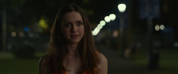 Movie still from “The King of Staten Island” (2020), directed by Judd Apatow – A beautiful young lady standing on a sidewalk at night; Close Up shot, Over the shoulder angle