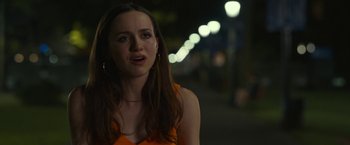 Movie still from “The King of Staten Island” (2020), directed by Judd Apatow – A woman in an orange top is standing in the street; Close Up shot, Over the shoulder angle
