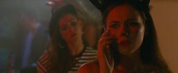 Movie still from “The King of Staten Island” (2020), directed by Judd Apatow – A woman on a cell phone in front of another woman; Close Up shot, Over the shoulder angle