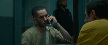 Movie still from “The King of Staten Island” (2020), directed by Judd Apatow – A man talking on a phone in front of a mirror; Close Up shot, Over the shoulder angle