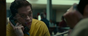 Movie still from “The King of Staten Island” (2020), directed by Judd Apatow – A man in a yellow shirt talking on a phone; Close Up shot, Low angle