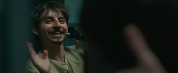 Movie still from “The King of Staten Island” (2020), directed by Judd Apatow – A man smiles while holding a phone in front of a mirror; Close Up shot, Over the shoulder angle