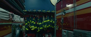 Movie still from “The King of Staten Island” (2020), directed by Judd Apatow – Many firemen uniforms hanging on the rack; Medium shot, High angle