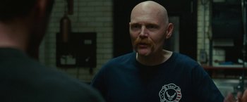 Movie still from “The King of Staten Island” (2020), directed by Judd Apatow – A man with a bald head is looking at the camera; Close Up shot, Over the shoulder angle