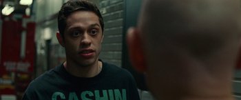 Movie still from “The King of Staten Island” (2020), directed by Judd Apatow – A man looking into a mirror while wearing a black t - shirt; Close Up shot, Over the shoulder angle