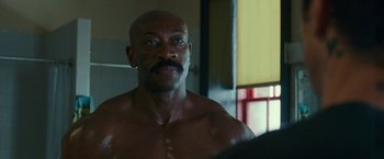 Movie still from “The King of Staten Island” (2020), directed by Judd Apatow – A man with a mustache looking into a mirror; Close Up shot, Over the shoulder angle
