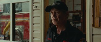 Movie still from “The King of Staten Island” (2020), directed by Judd Apatow – An older man wearing a hat and looking at the camera; Close Up shot, Over the shoulder angle