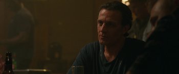 Movie still from “The King of Staten Island” (2020), directed by Judd Apatow – A person sitting at a table with a glass; Close Up shot, Over the shoulder angle