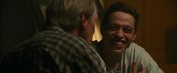 Movie still from “The King of Staten Island” (2020), directed by Judd Apatow – A man and a woman smiling at each other; Close Up shot, Over the shoulder angle