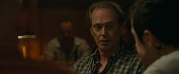 Movie still from “The King of Staten Island” (2020), directed by Judd Apatow – An older man in a checkered shirt is looking at the camera; Close Up shot, Over the shoulder angle