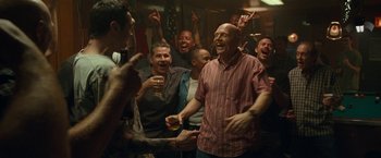 Movie still from “The King of Staten Island” (2020), directed by Judd Apatow – A group of men standing around each other in a room; Medium shot, High angle
