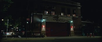 Movie still from “The King of Staten Island” (2020), directed by Judd Apatow – A fire station at night lit by street lights; Extreme Wide shot, Low angle