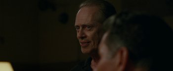 Movie still from “The King of Staten Island” (2020), directed by Judd Apatow – An older man looking at the camera while sitting down; Close Up shot, Over the shoulder angle