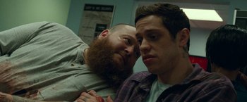 Movie still from “The King of Staten Island” (2020), directed by Judd Apatow – A man with a beard is leaning on another man's shoulder; Close Up shot, Over the shoulder angle